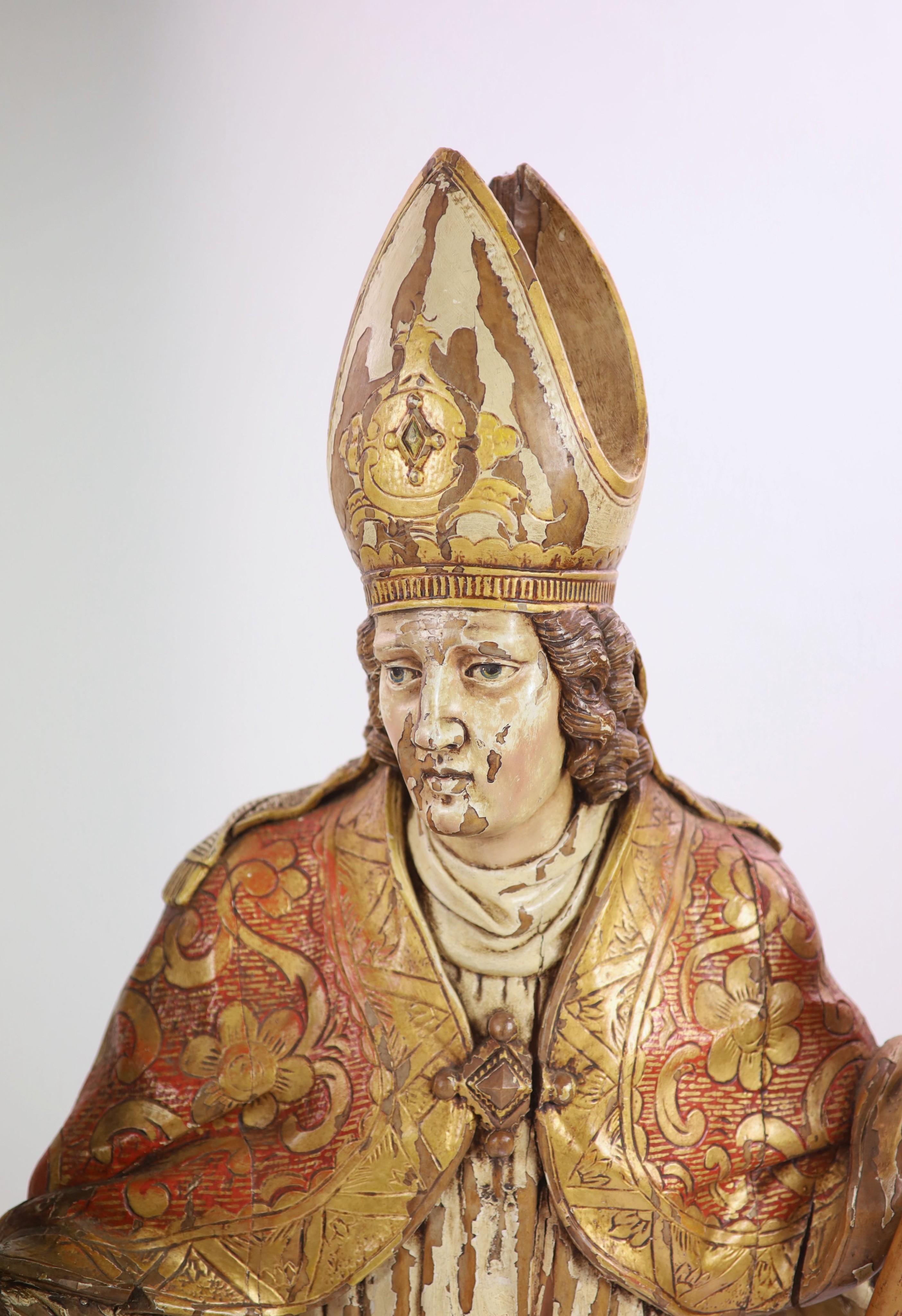 A 19th century German painted carved wood figure of St Ludgerus (b.742) H 157cm.